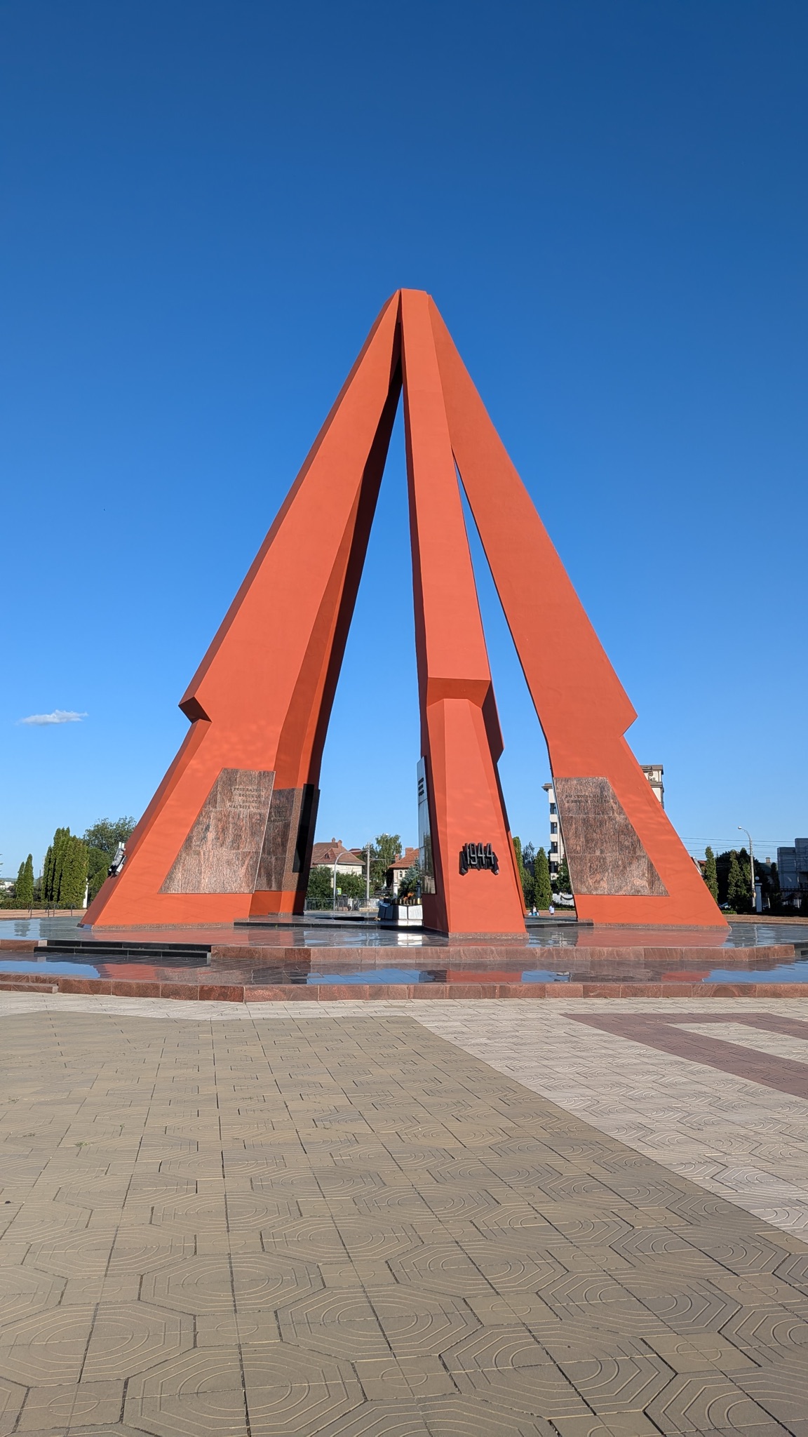 The Eternity Memorial in Chisinau, a pyramid-shaped monument in red-orange pillars marking 1944, with an eternal flame at its base