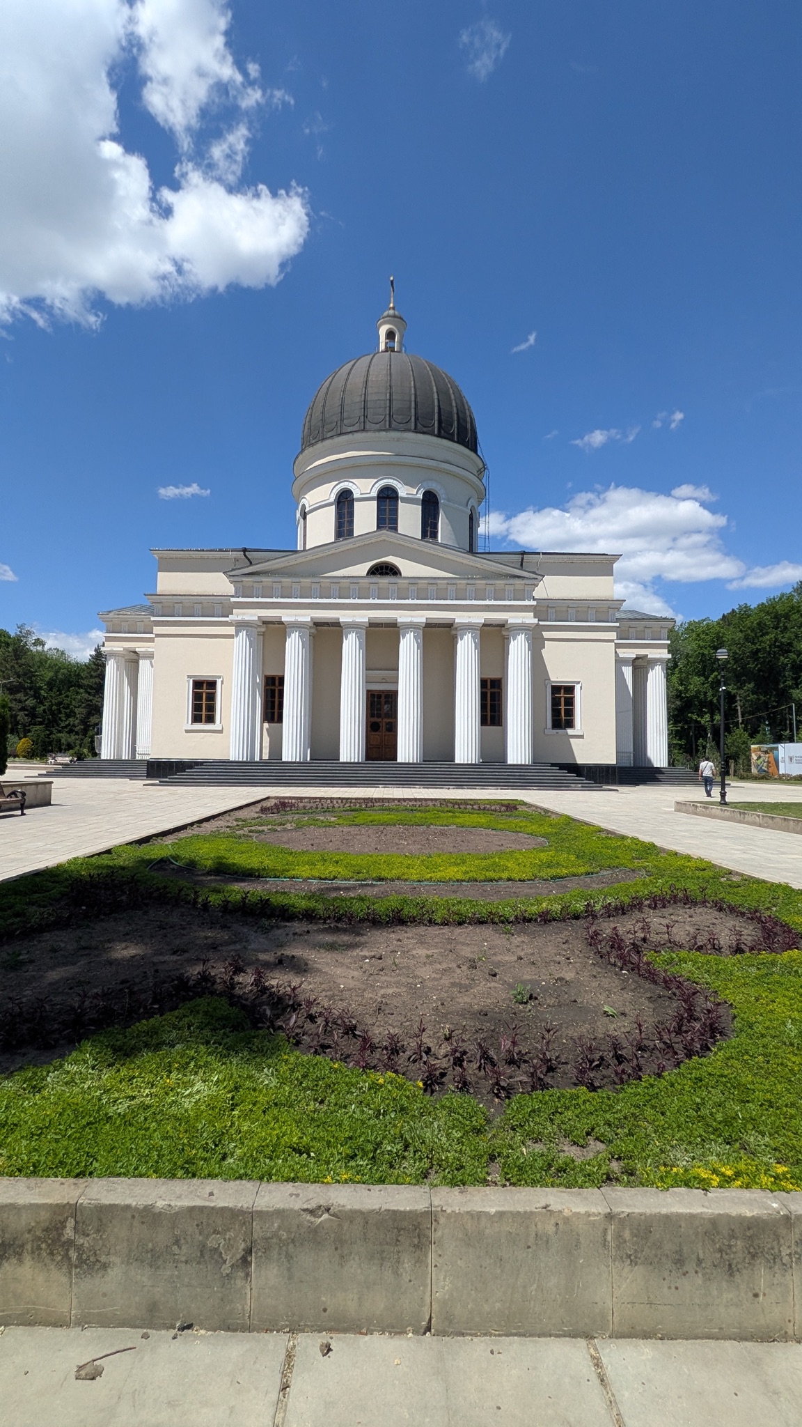 The Nativity Cathedral in Chisinau, Moldova, with its white columns and central dome under a blue sky