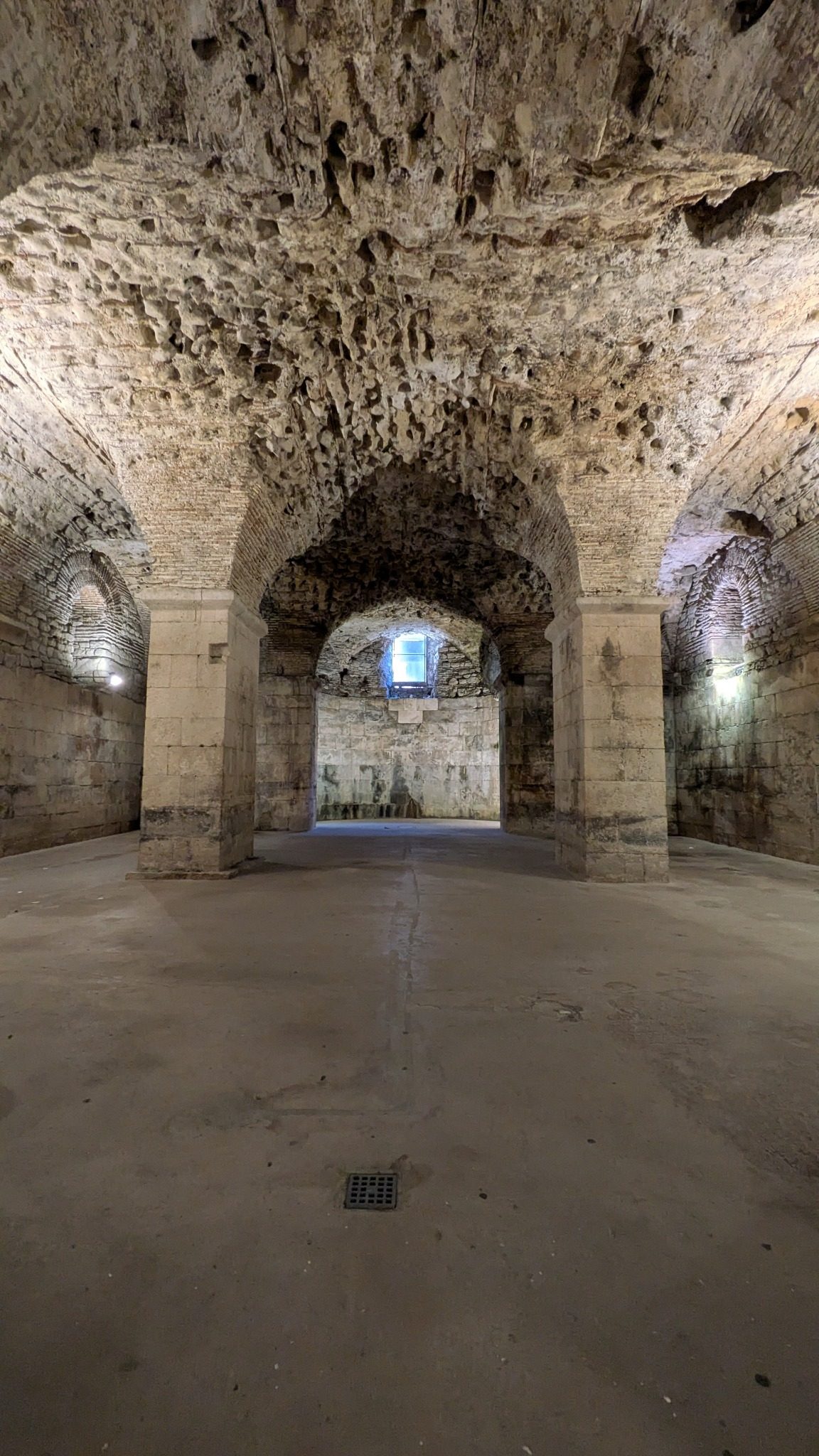 Stone arches and rough ceilings inside the underground cellars of Diocletian's Palace in Split